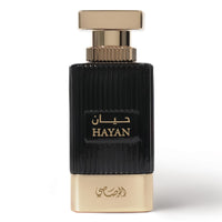 Perfume bottle with black and gold design on a white background